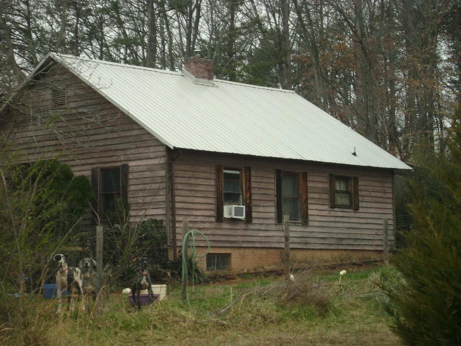White metal roof on an old wood sided farmhouse, from a Metal Roof Installation job in New Ringgold